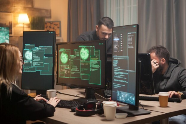 Female hacker with her team of cyber terrorists making a dangerous virus to attack the government.
